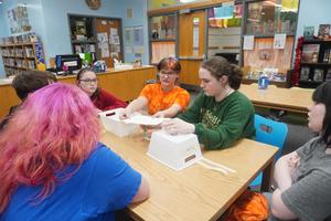A team tries to build a bridge between two baskets.