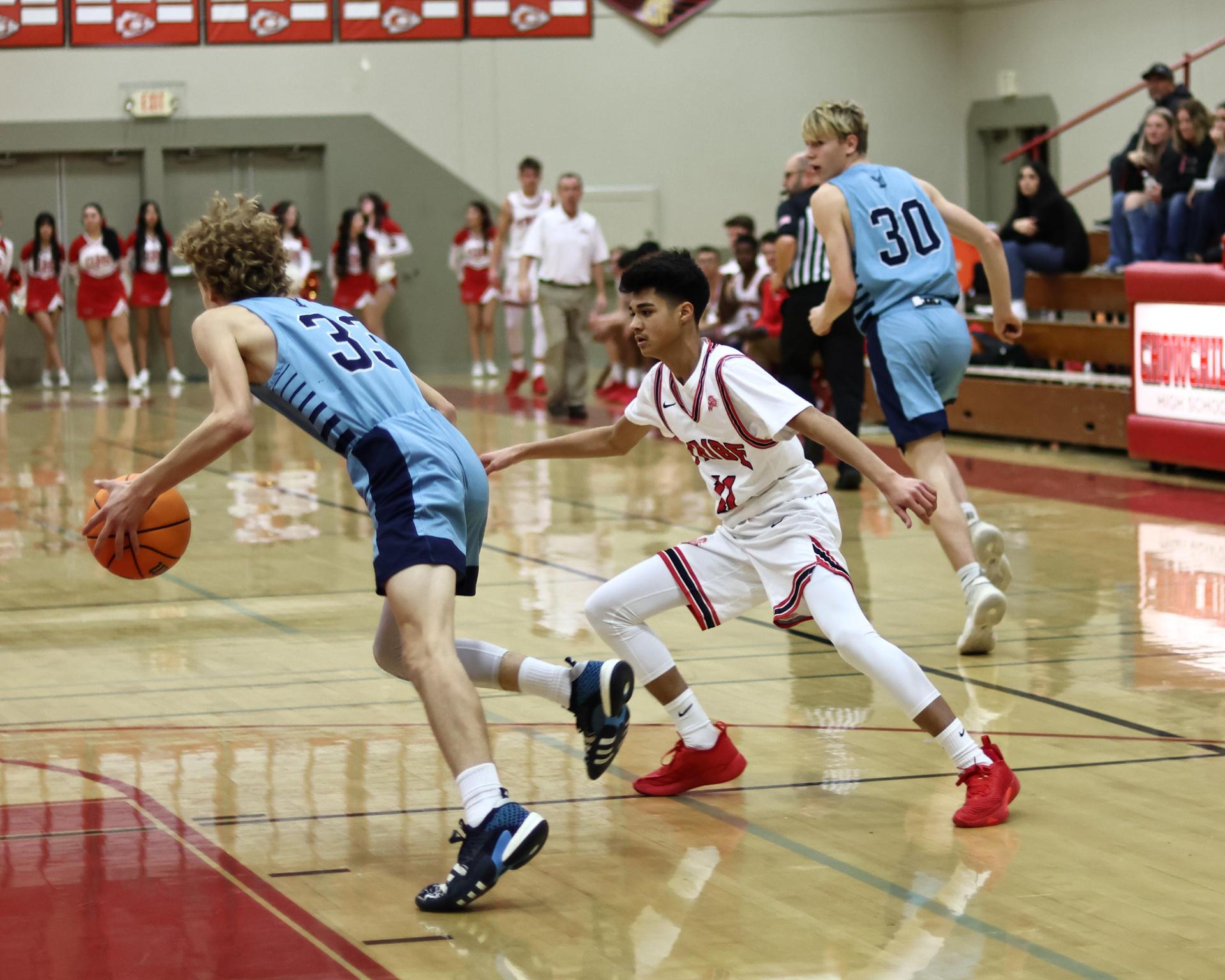 Varsity boys playing basketball against yosemite