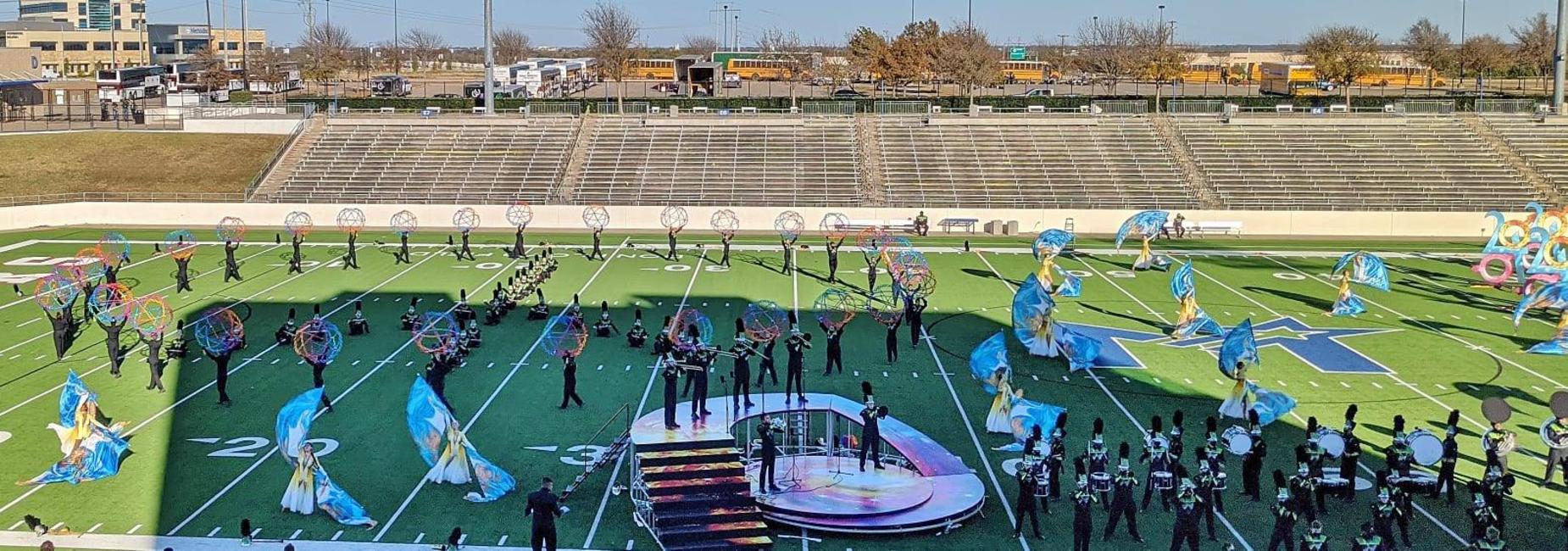 marching band performing in uniform on the field