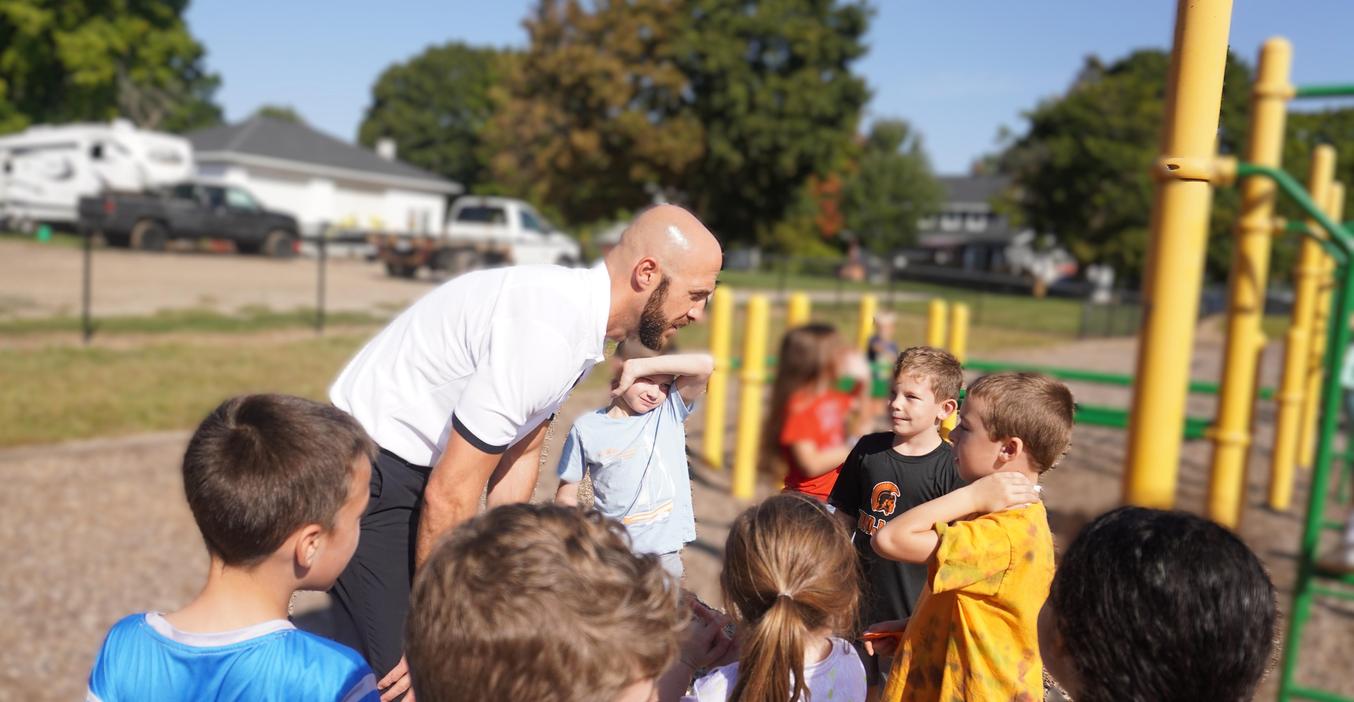 McFall Principal Sleeman talks with students on the playground.