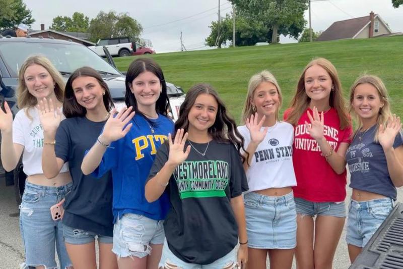 Seniors Gabriella Naglich, Emma Connelly, Isabella Naglich, Harlie Mull, Adalyn Hawk, Mara Germanoski, and Ella Mains wear shirts depicting their college selections
