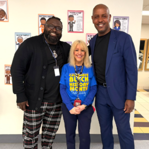 Guest speaker and staff at Global Village Academy Aurora Black History Month event