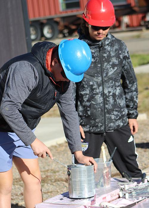 Students open a paint can.