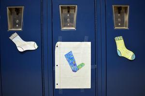 Colorful paper socks stuck to lockers