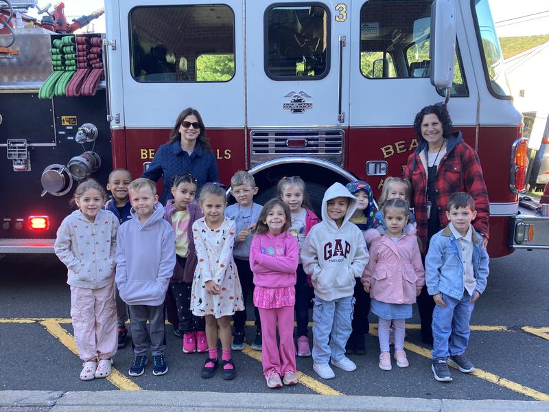 students teacher and fire truck for fire prevention day