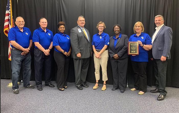  C.C.I.S.D. Board of Trustees poses with the plaque