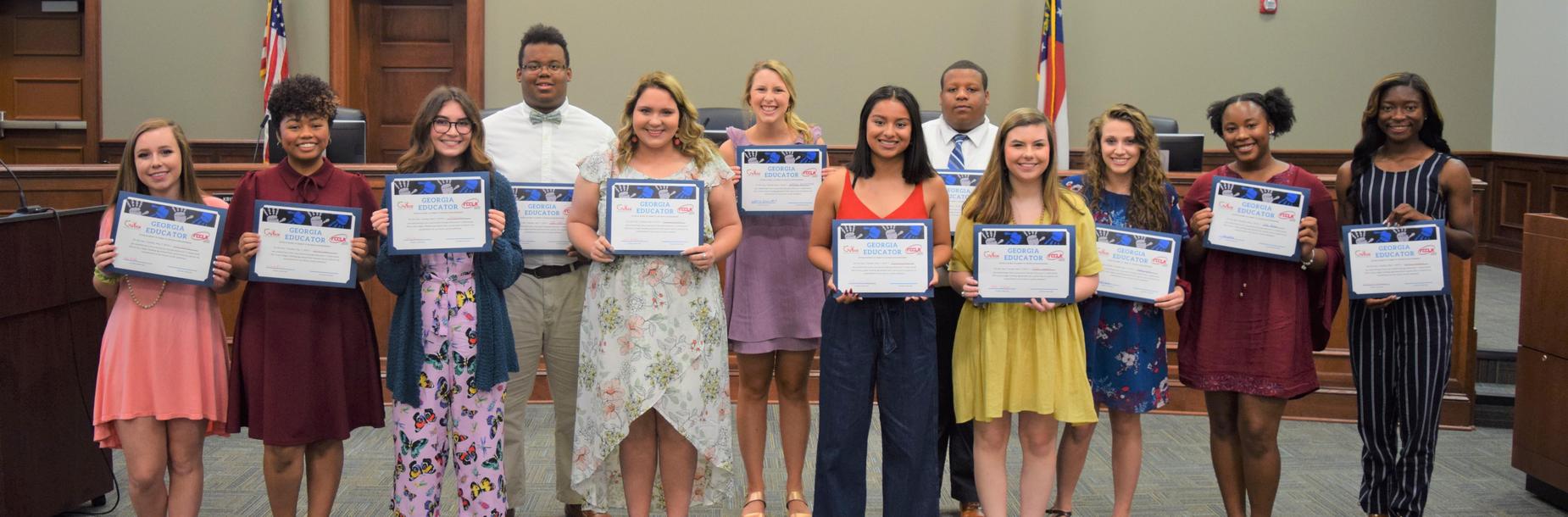 Students holding certificates