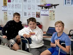 Students working with drones in a STEAM classroom.