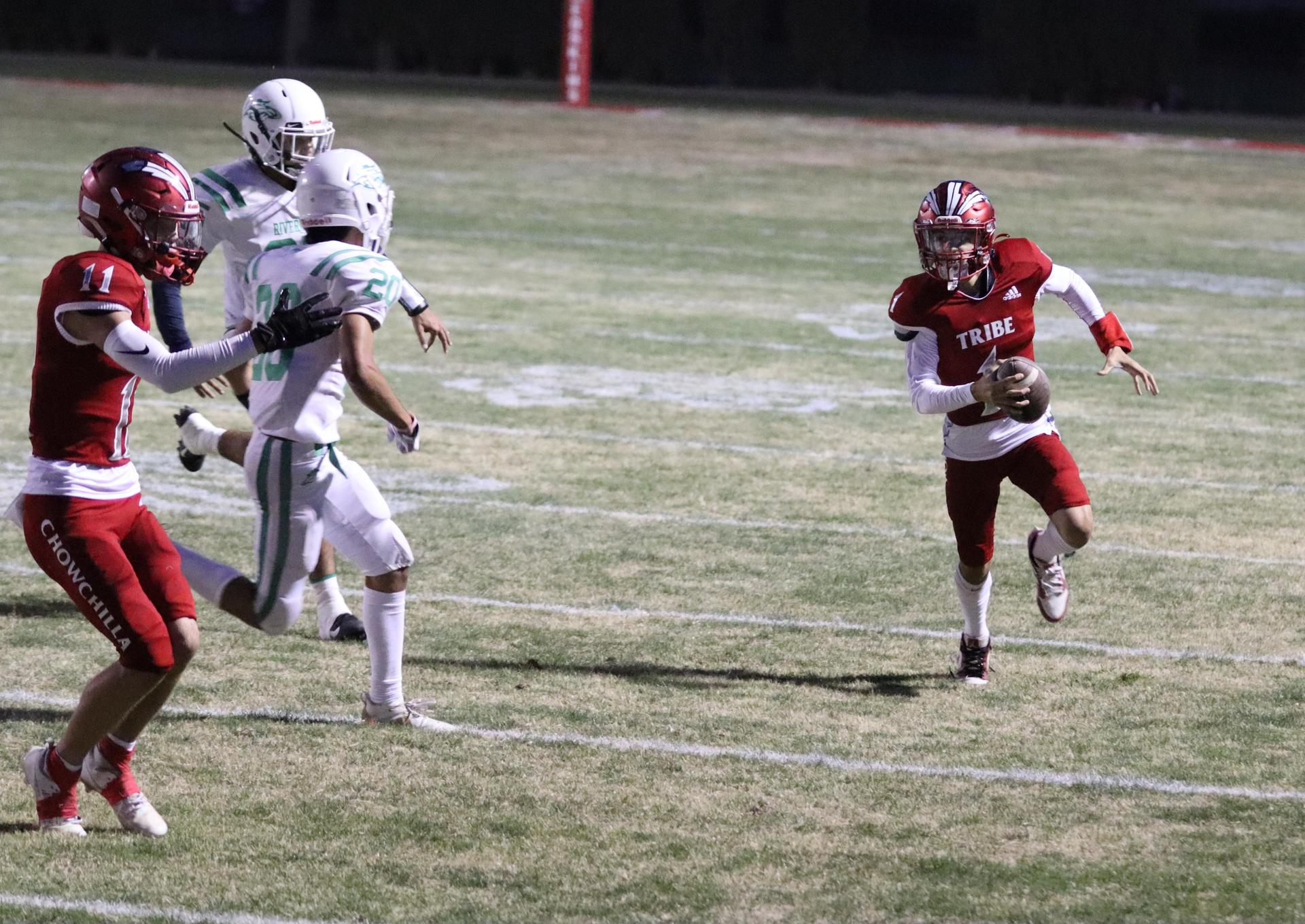 varsity football players in action against Riverdale