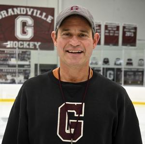 portrait of Joel Breazeale wearing a Grandville sweatshirt at the ice rink