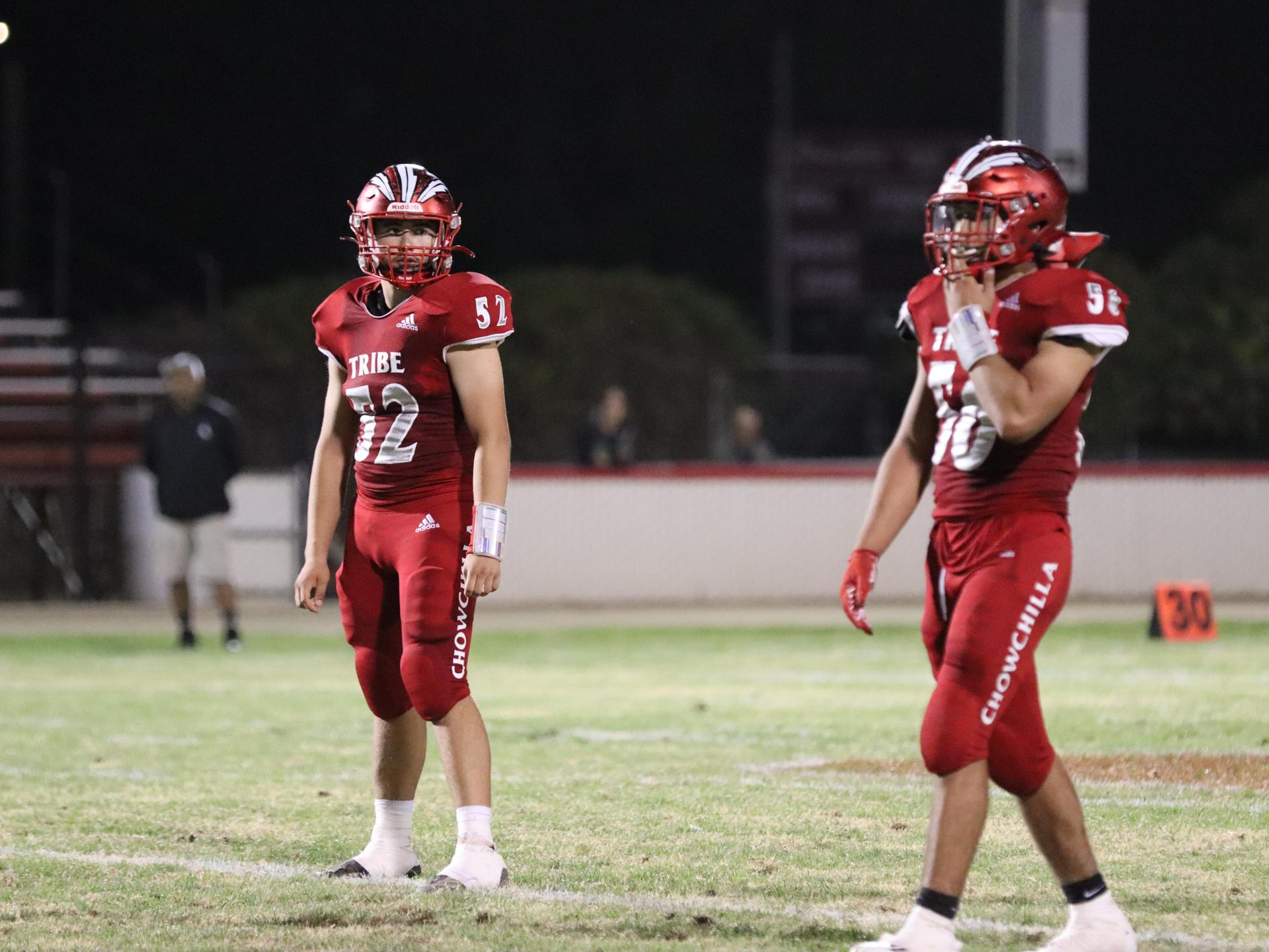 varsity football players in action against Riverdale