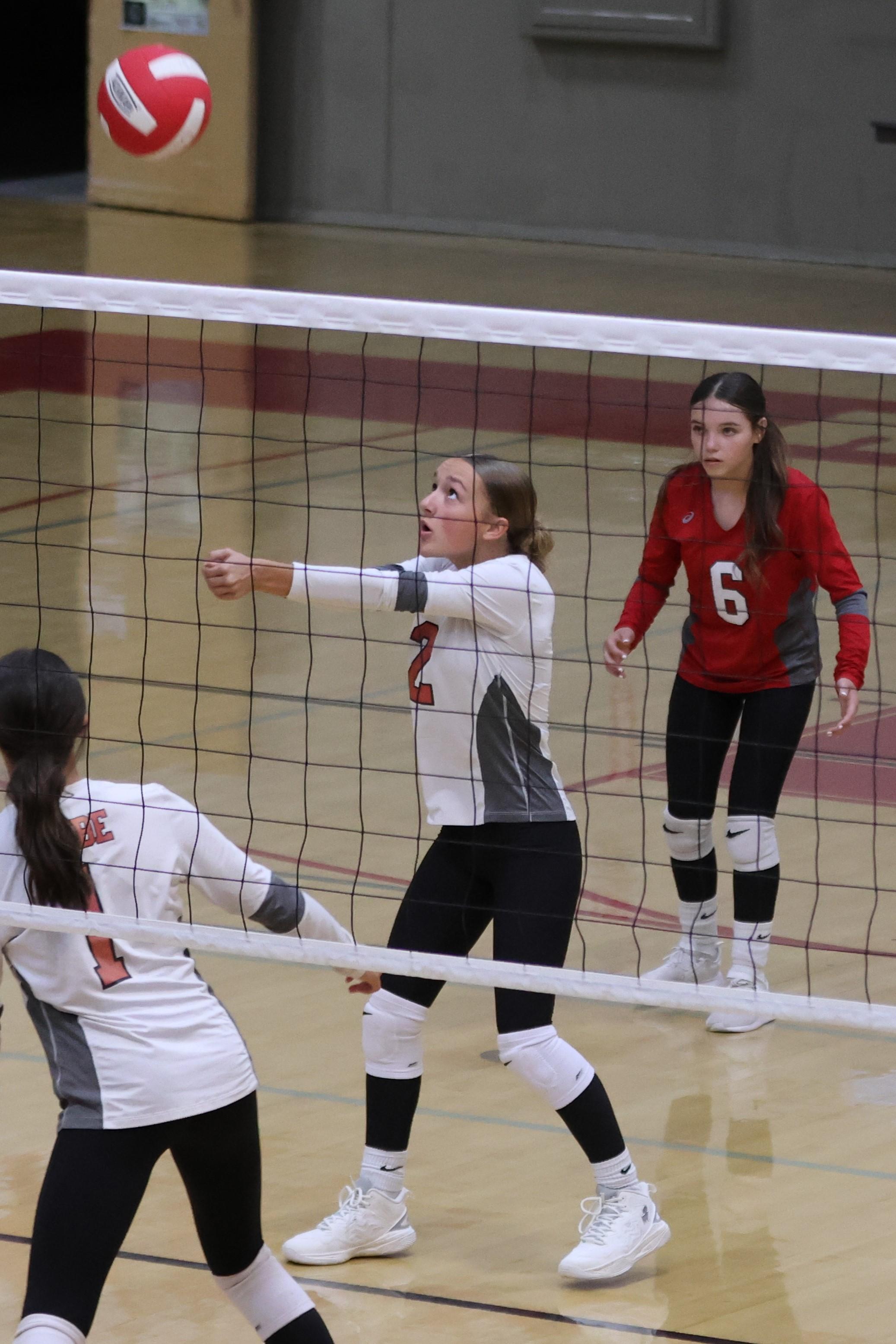 junior varsity girls playing volleyball 70