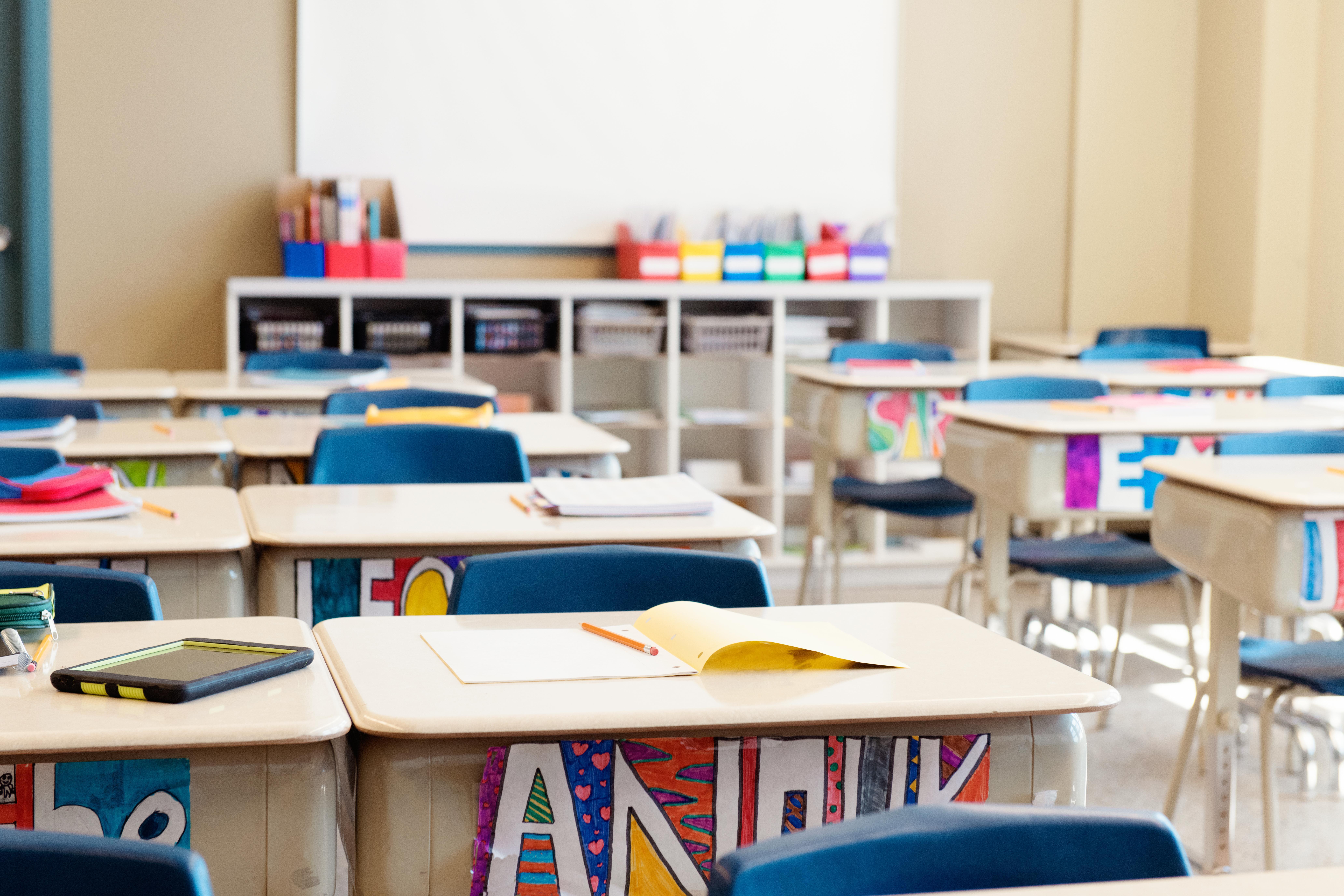 Student desks with art supplies on them.