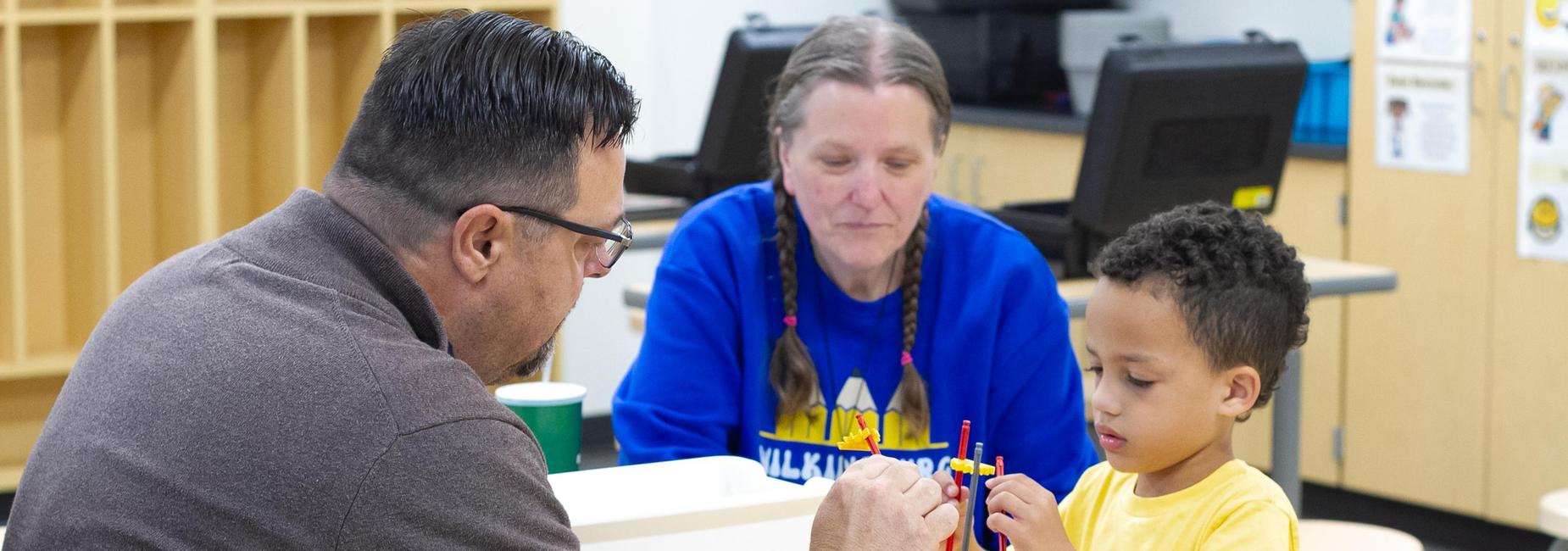 teachers working with student