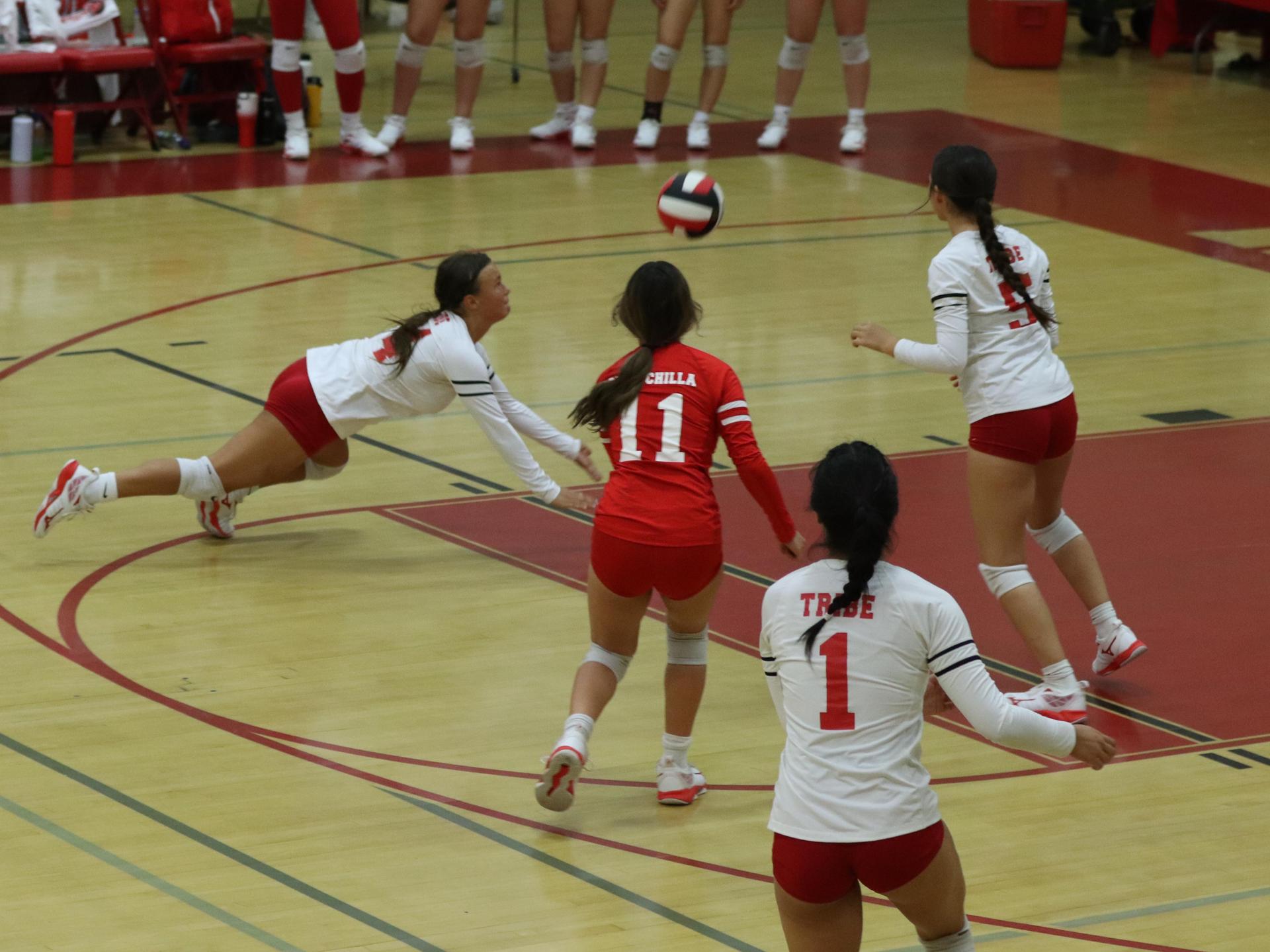 varsity volleyball players in action against golden valley