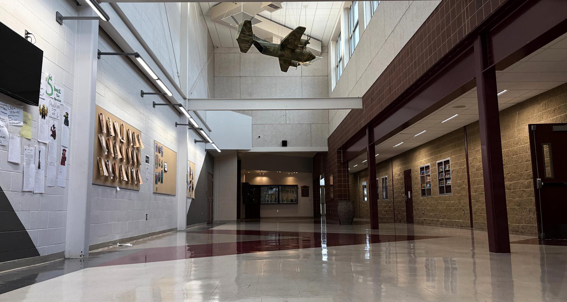 Interior hallway featuring displays, a model aircraft, and polished floors.