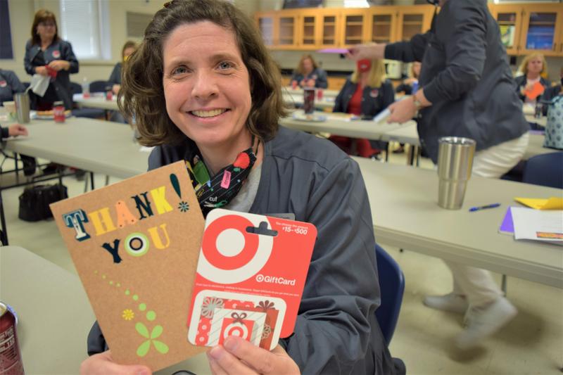 school nurse holding cards smiling