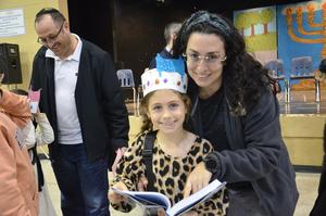 A mother and a daughter pose together after the play.