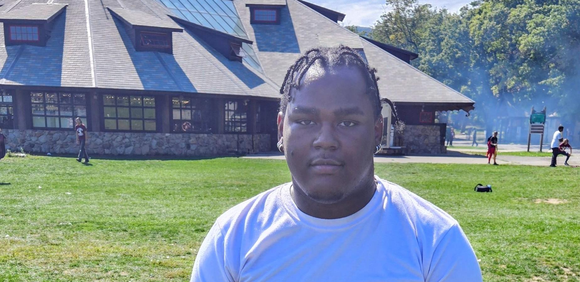 Student poses for community building trip.