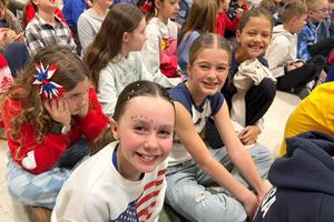 Third-graders Anzi Mastroianni, Bea Burmeister and Ella Deflavio show their patriotism at the schoolwide assembly