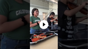YouTube thumbnail with students readying their violins to play.