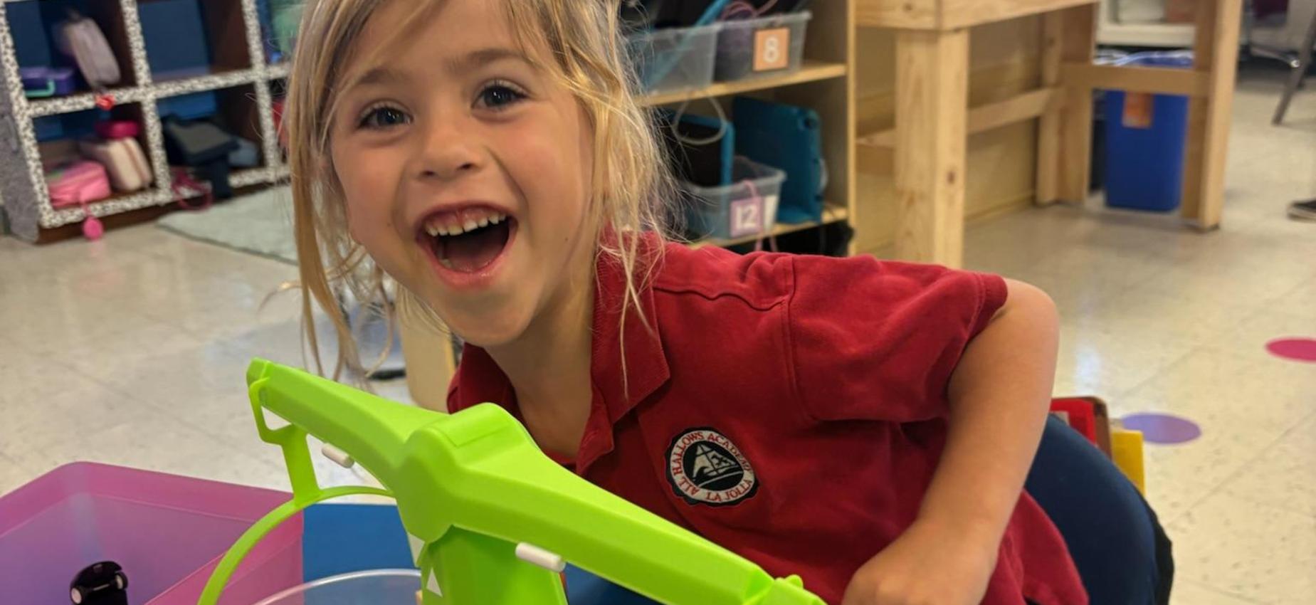 Kindergarten student posing as she learns about weight and balances