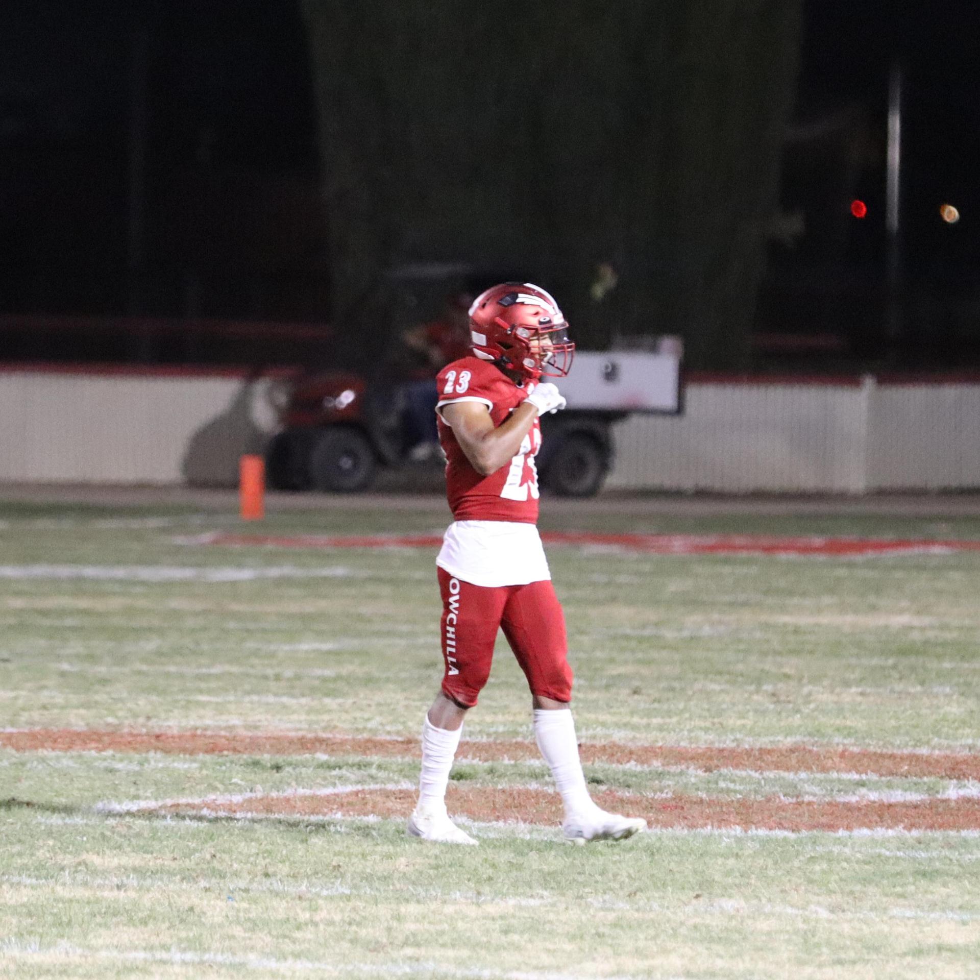varsity football players in action against Riverdale