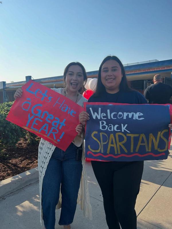 staff hold up signs of encouragement