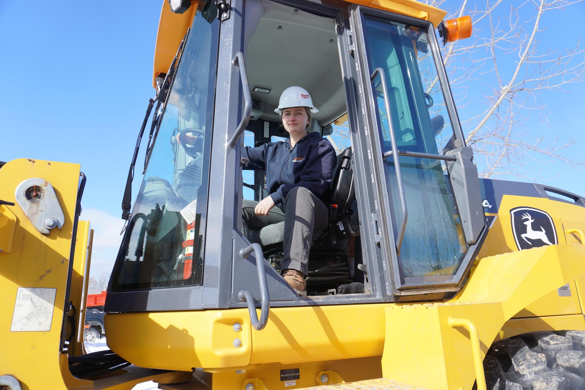 Heavy equipment student in front of excabator