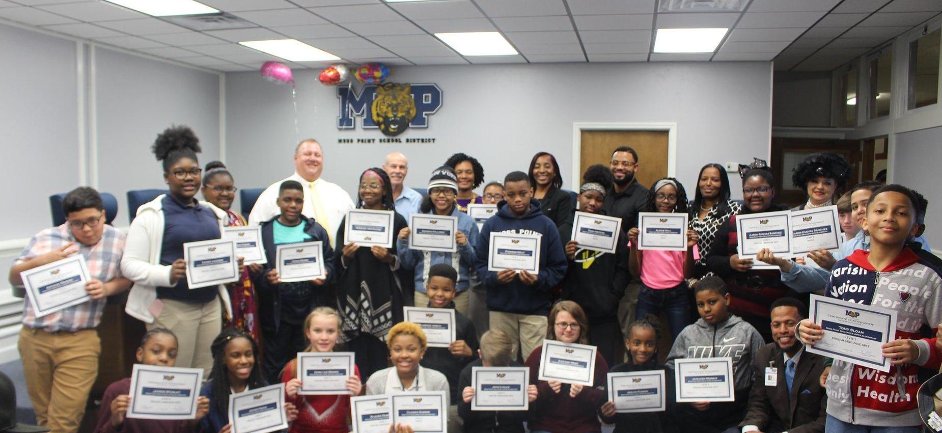 students at board meeting receiving recognition