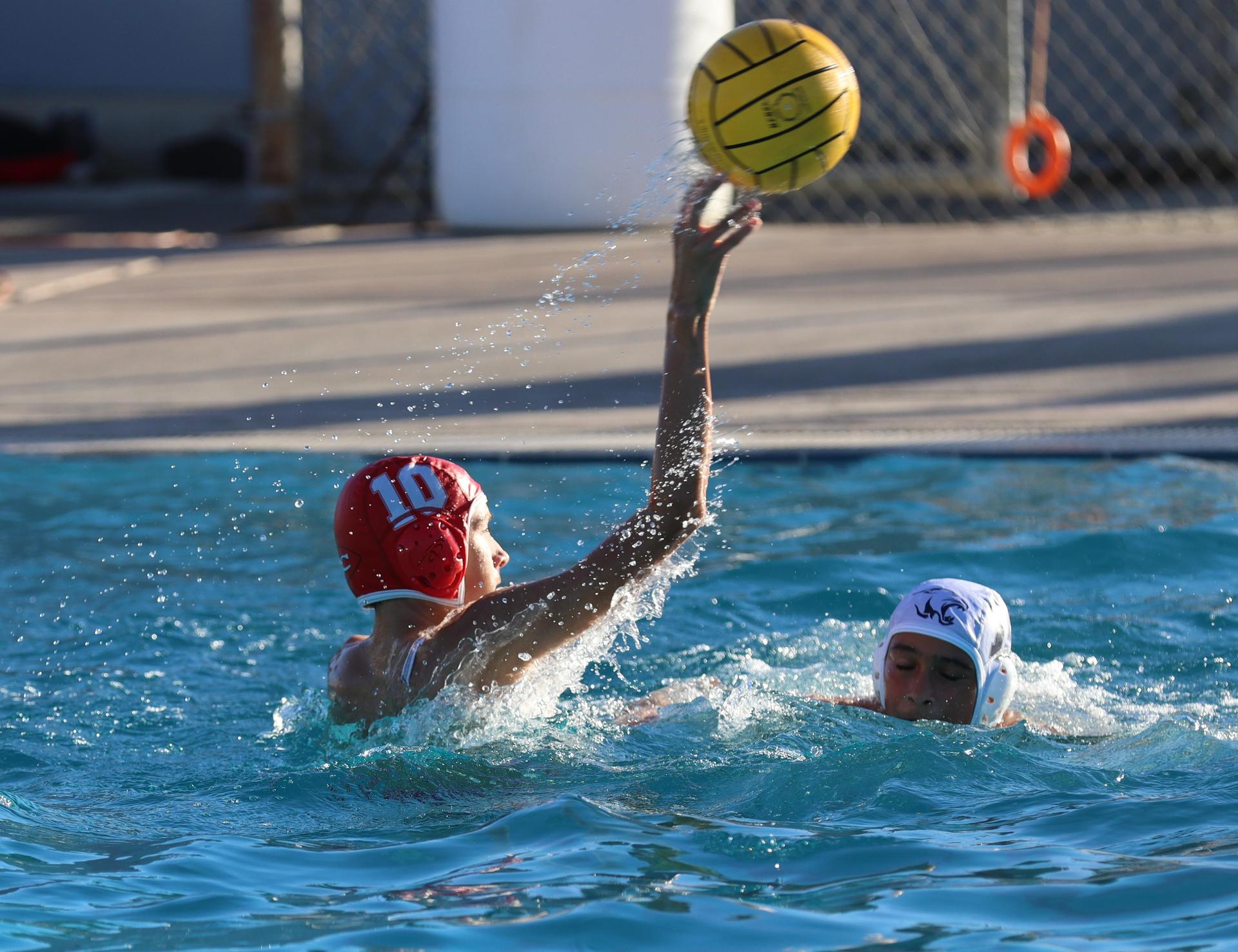 boys water polo players in action against san joaquin memorial