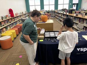 A student selects frames for new glasses