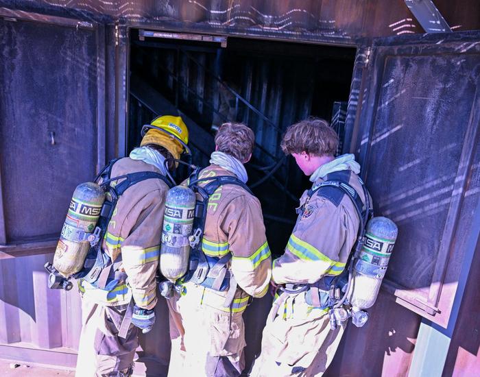 fire science students looking in window