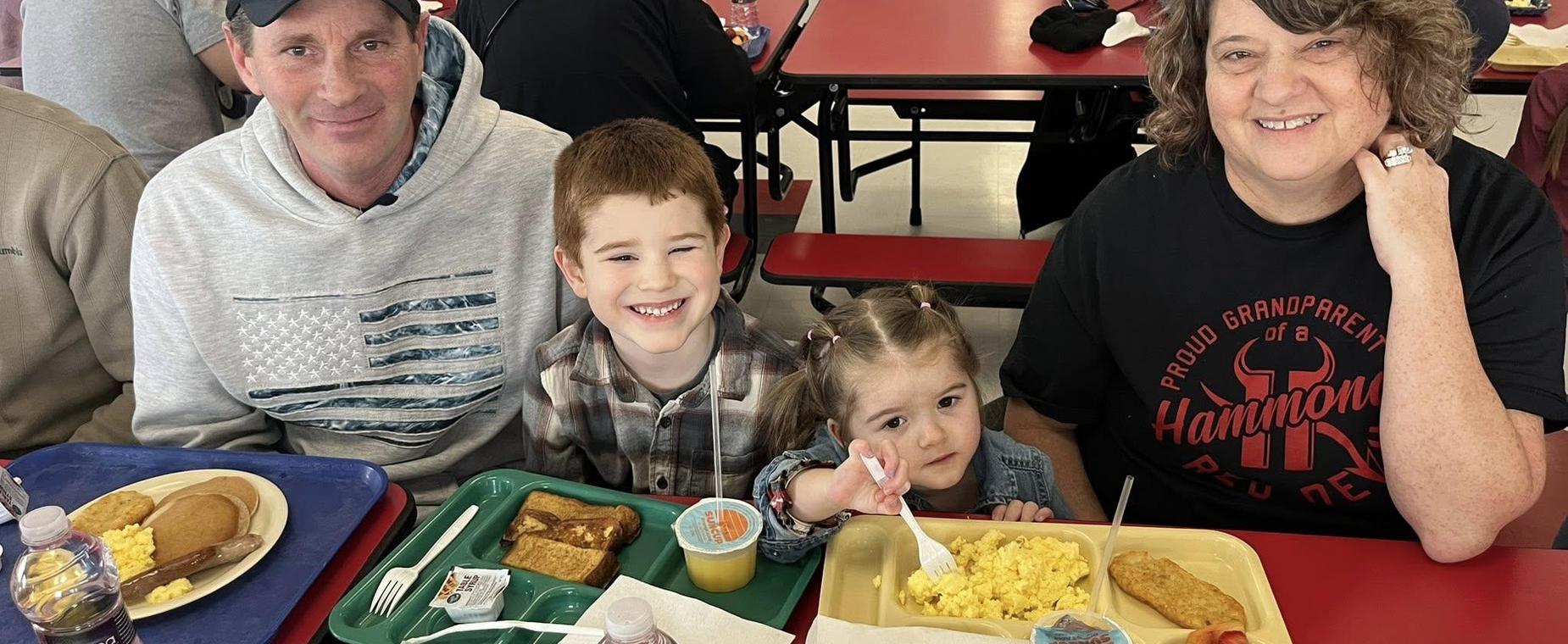 students with grandparents at breakfast