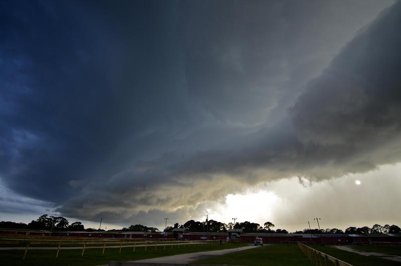 A storm cloud hovers over an area.