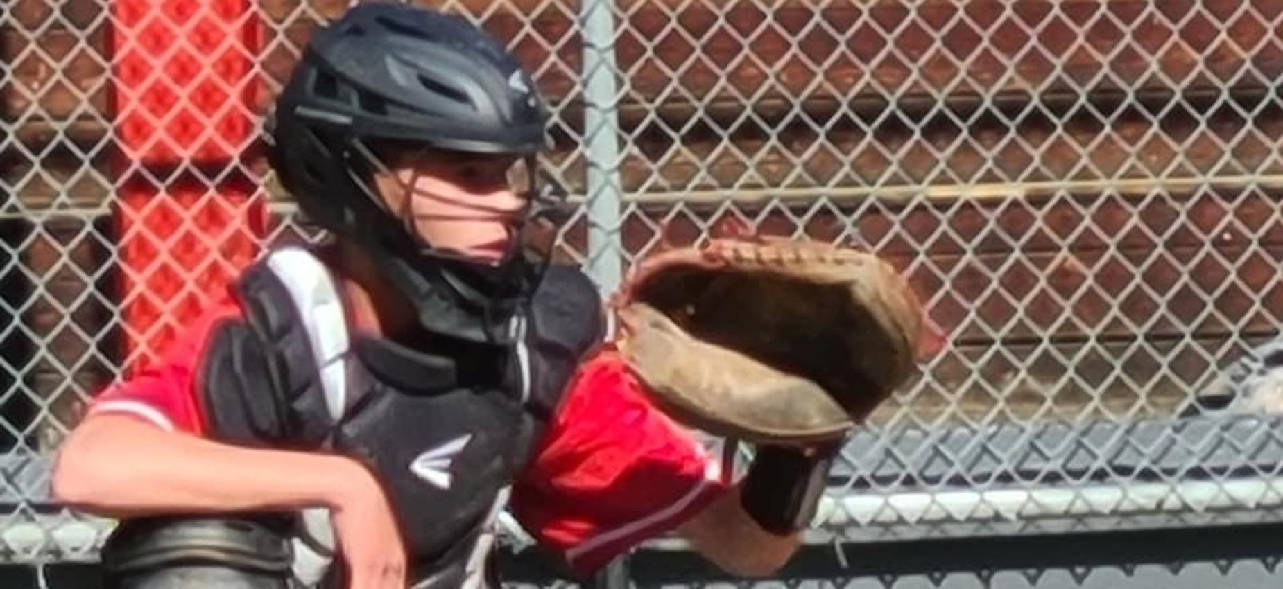 A baseball catcher waits to catch the ball.