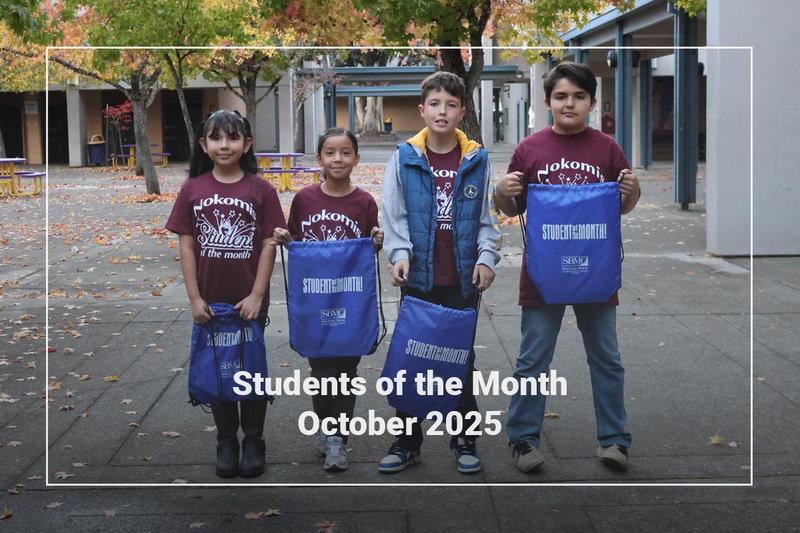 Students holding a bag