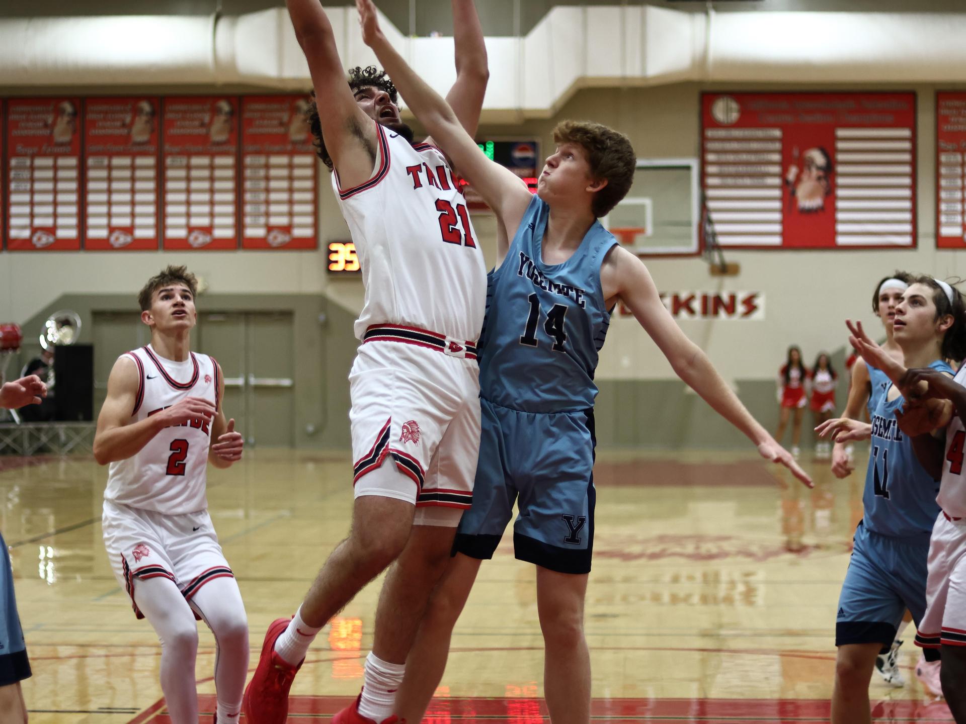 Varsity boys playing basketball against yosemite