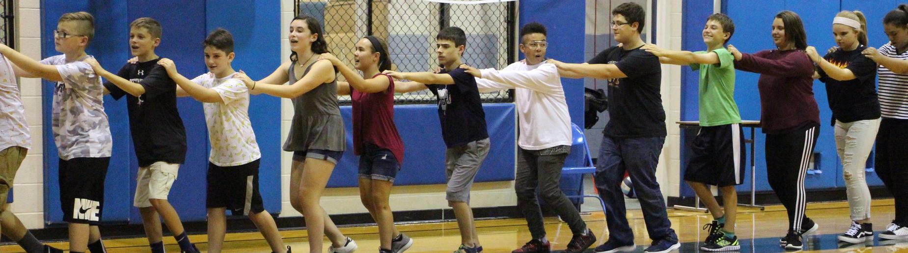 Gananda Middle Schoolers learn communication through a human chain exercise
