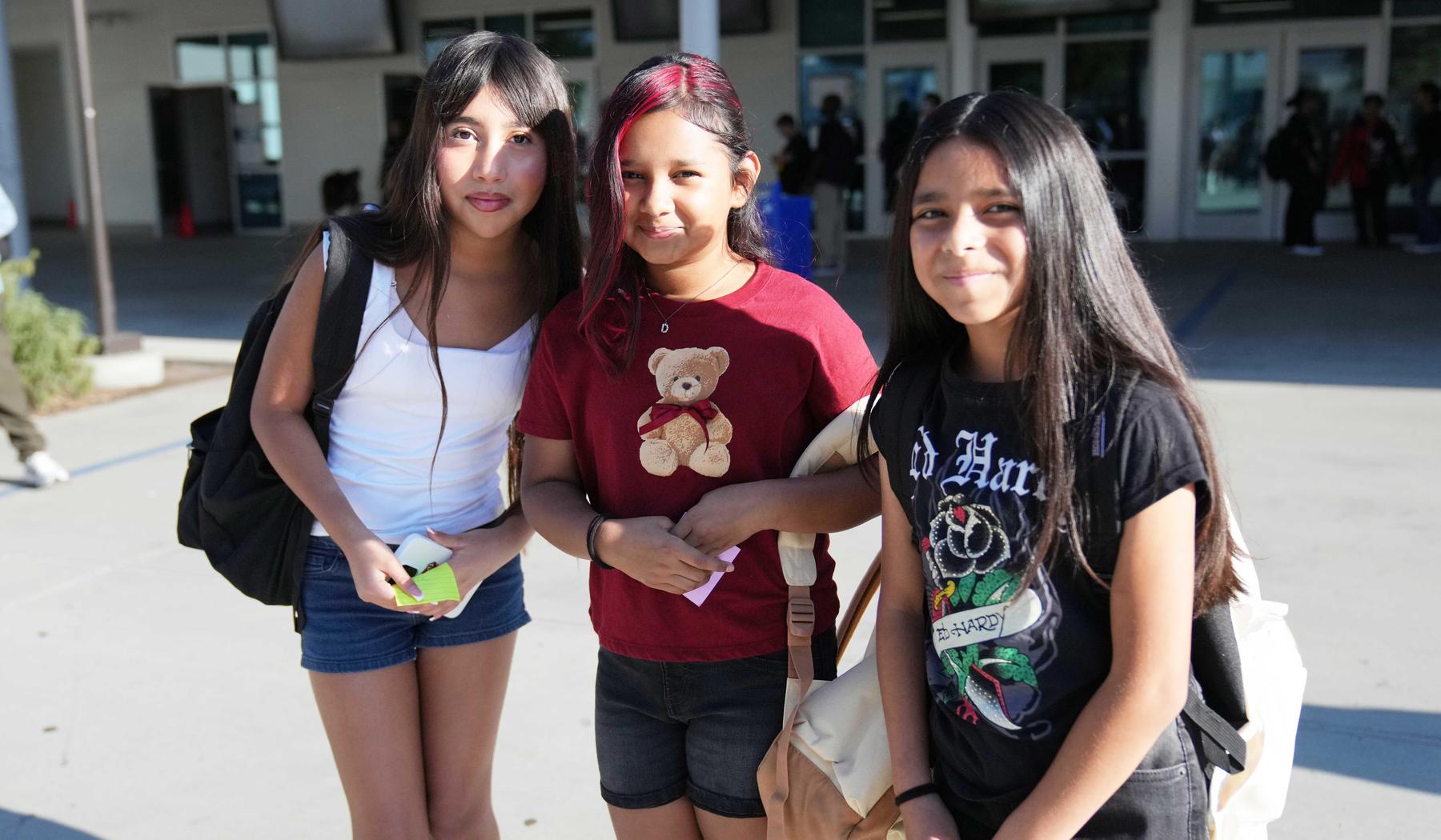 3 smiling middle school students