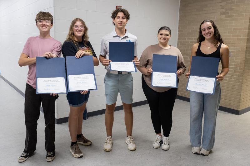Five high school students pose with their certificates