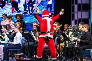 Santa appears on stage with the concert band