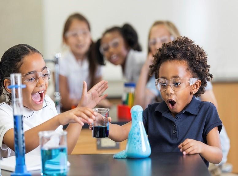 students in classroom science lab with beakers