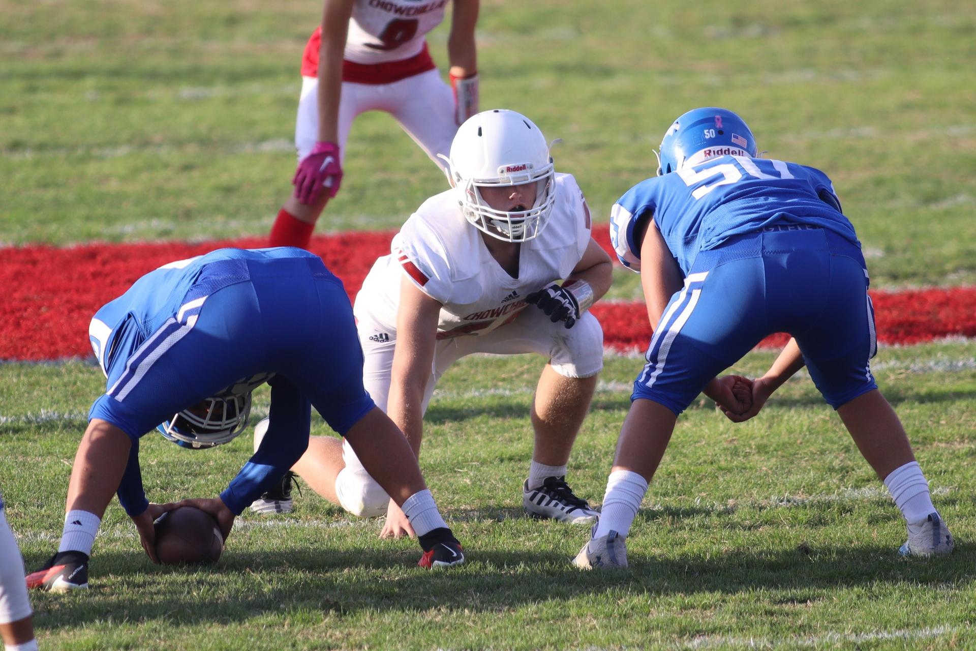 Junior Varsity football players in action against Caruthers