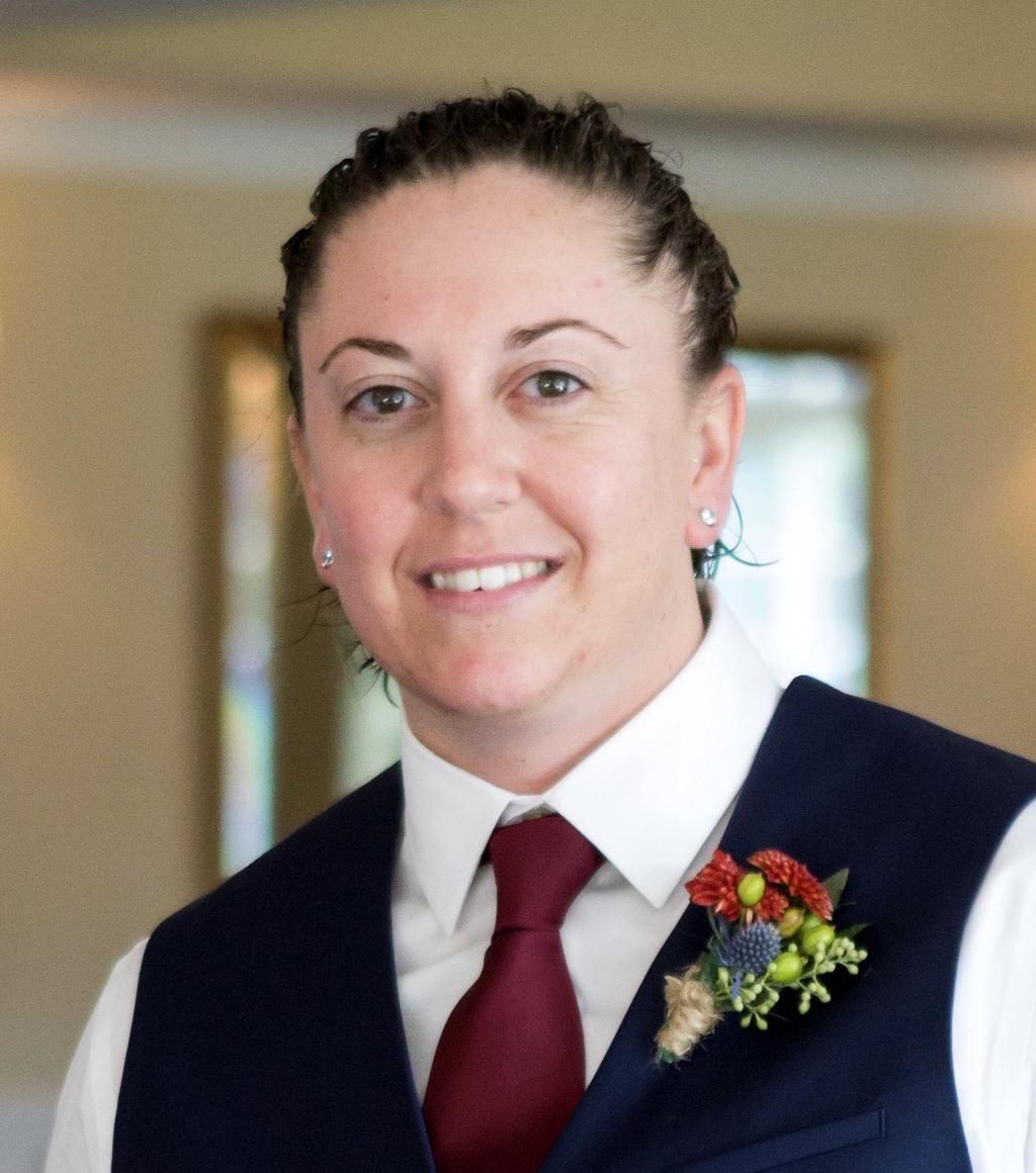 Head shot, woman smiling, wearing formal attire