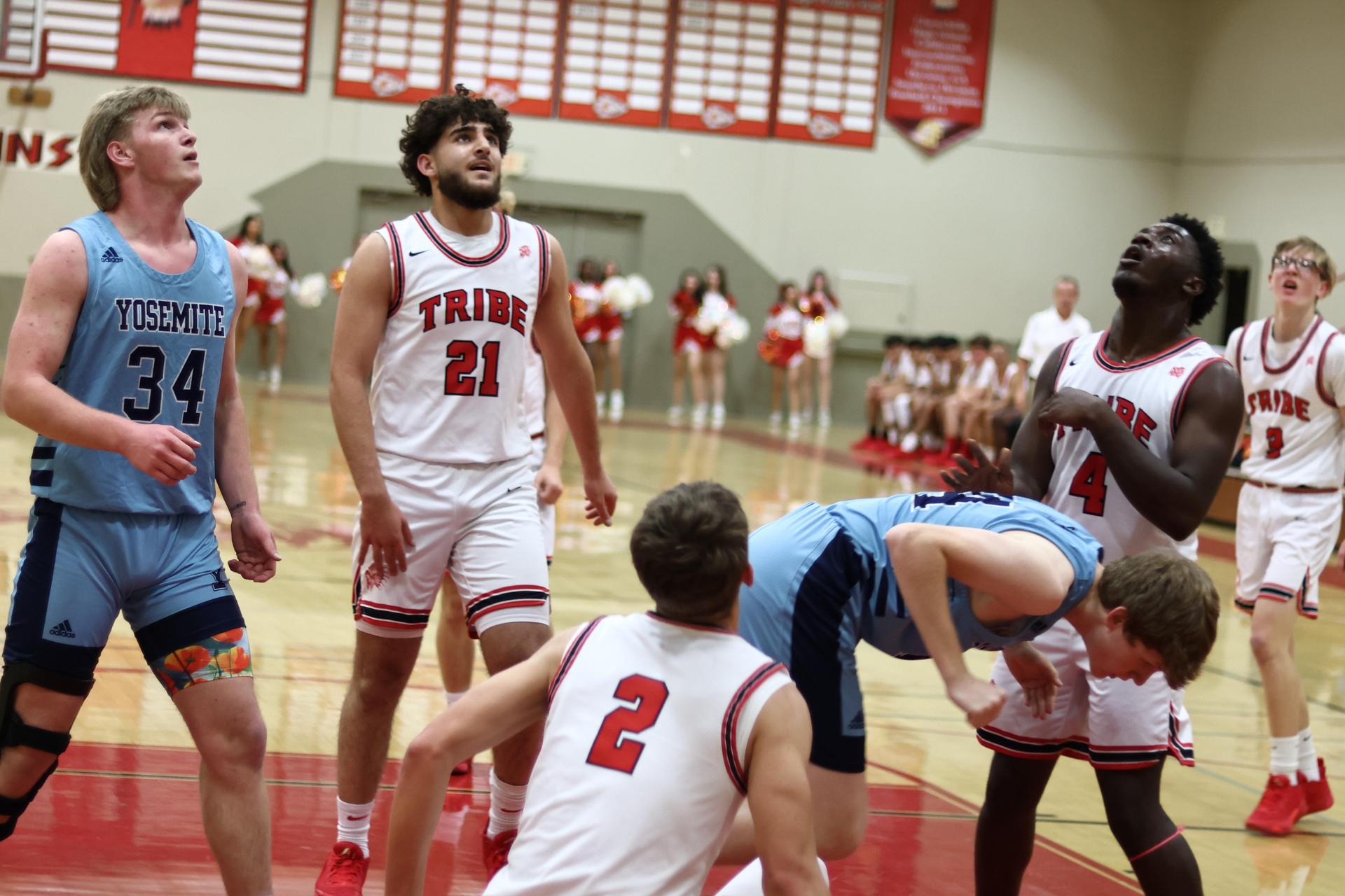 Varsity boys playing basketball against yosemite