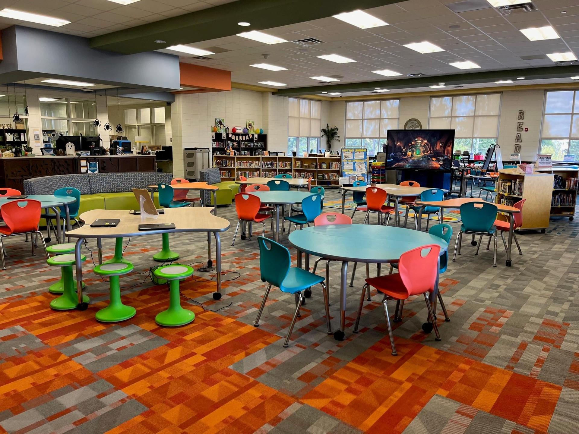 Grovetown Learning Commons space including tables, chairs, and shelves of books.