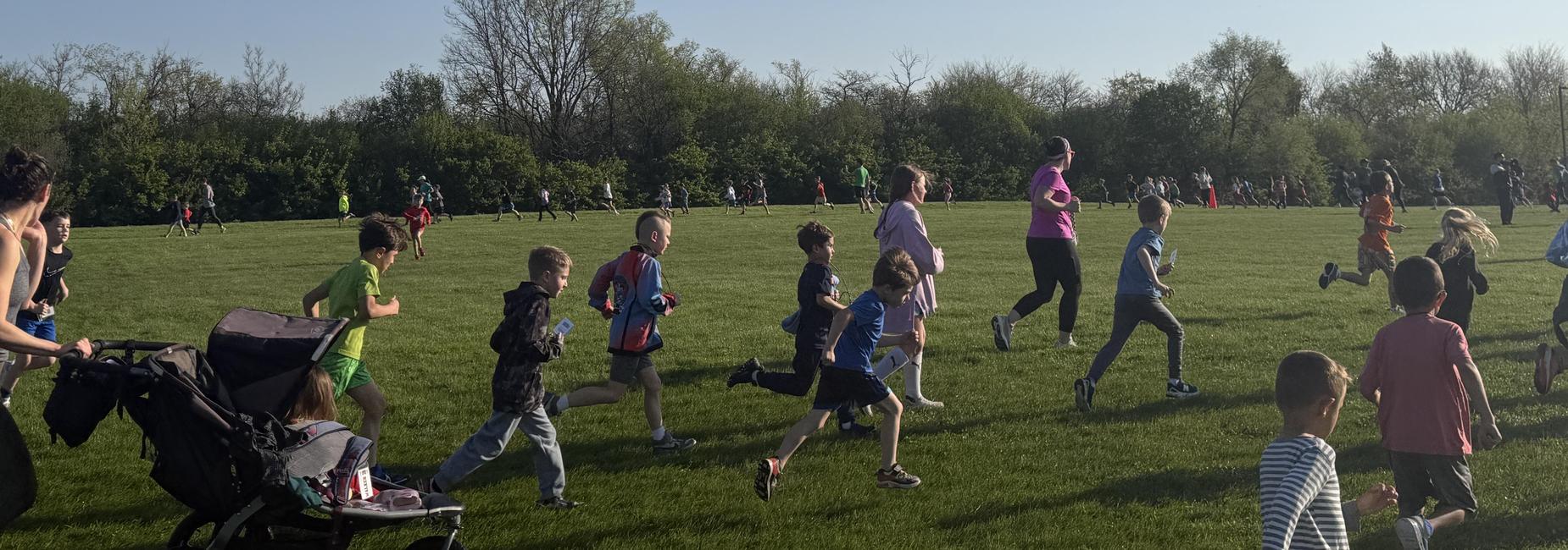 Students and their families running in thegrass