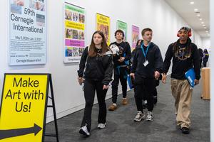 Students walk down an art-decorated hallway