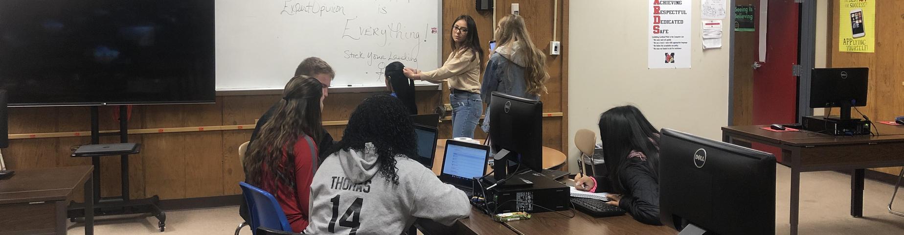 MHS student Julissa, is being videoed for her college Public Speaking Class. Other students at MHS is her audience. One of the requirements for this class is to have so many people present during the presentation.